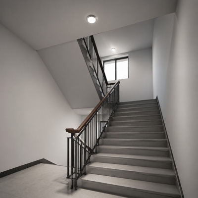 Infrared presence sensor installed in stairwell for automatic lighting control